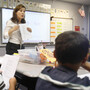 Second-grade teacher Vickie Boudouris goes over a worksheet in an English-learner summer school class at the Cordova Villa Elementary School in June, in Rancho Cordova, Calif. Under Gov. Jerry Brown's proposed budget, California schools will receive an additional $3.6 billion this year, with much of it targeted to the neediest students.