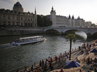 People enjoy the sun next to Pont Neuf bridge as "Paris Plage, or Paris Beach, opens along the banks of the Seine river in Paris, on July 20. The annual free event brings a half-mile of beach into the heart of the French capital. People enjoy the sun next to Pont Neuf bridge as "Paris Plage, or Paris Beach, opens along the banks of the Seine river in Paris, on July 20. The annual free event brings a half-mile of beach into the heart of the French capital.