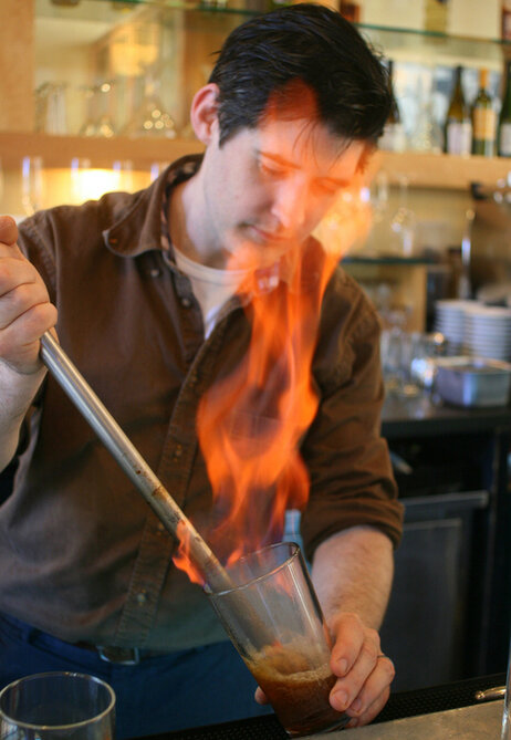 Flip back in time: Chef David Arnold mixes up a drink with a blazing-hot metal rod, a method similar to how bartenders used to make the flip cocktails that were wildly popular in colonial New England. Flip back in time: Chef David Arnold mixes up a drink with a blazing-hot metal rod, a method similar to how bartenders used to make the flip cocktails that were wildly popular in colonial New England.