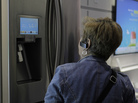 A woman checks out a smart refrigerator at a consumer electronics show in 2012. A woman checks out a smart refrigerator at a consumer electronics show in 2012.