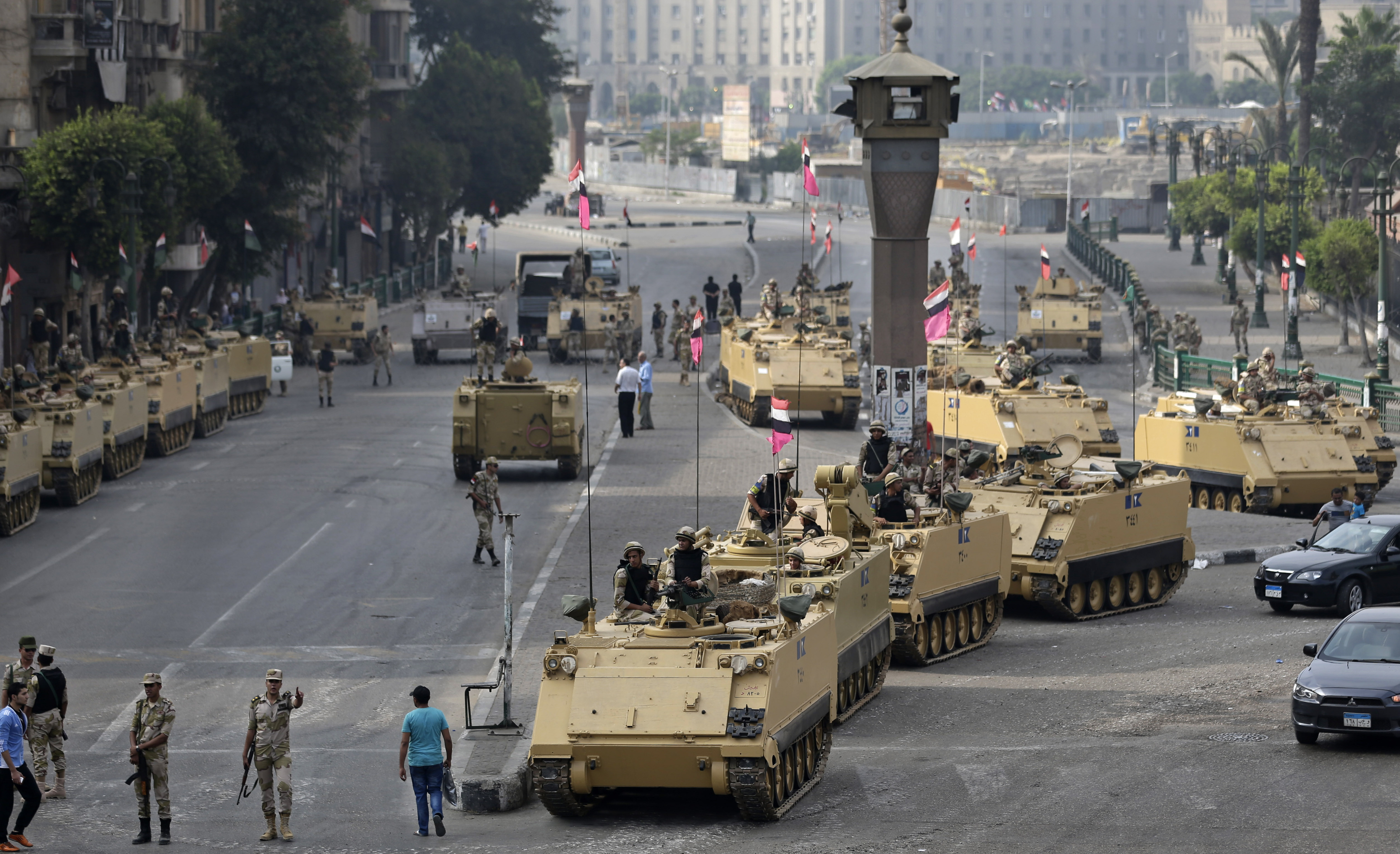 Egyptian army soldiers take their positions on top and next to their armored vehicles while guarding an entrance to Tahrir square in Cairo on Friday. Egyptian army soldiers take their positions on top and next to their armored vehicles while guarding an entrance to Tahrir square in Cairo on Friday.