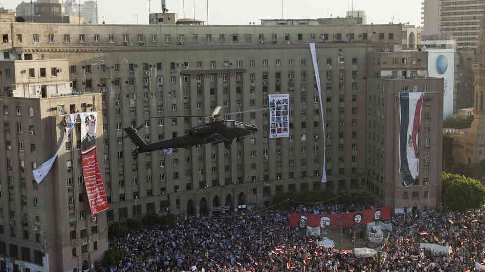 An Egyptian Apache helicopter flies over a crowd of pro-military demonstrators at Tahrir Square in Cairo on July 26. U.S. firms supply military hardware to the military, including the Apache helicopters. An Egyptian Apache helicopter flies over a crowd of pro-military demonstrators at Tahrir Square in Cairo on July 26. U.S. firms supply military hardware to the military, including the Apache helicopters.