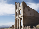 An abandoned building sitting in a wasteland. An abandoned building sitting in a wasteland.