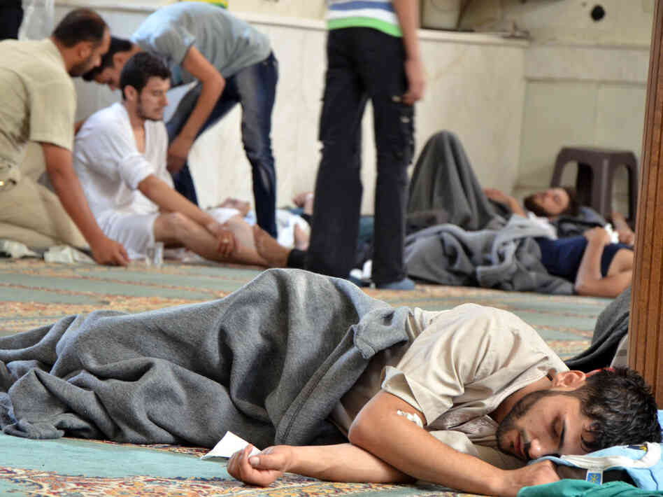 A survivor from what activists say was a chemical weapons attack rests inside a mosque in the Duma neighborhood of Damascus, Syria, on Wednesday. A survivor from what activists say was a chemical weapons attack rests inside a mosque in the Duma neighborhood of Damascus, Syria, on Wednesday.