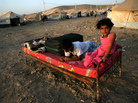 Syrian-Kurdish children sit on a bed at the Quru Gusik refugee camp in the Kurdish region of northern Iraq, on Aug. 22. Faced with brutal violence and soaring prices, thousands of Syrian Kurds have poured into Iraq's autonomous Kurdish region. UNICEF has reported that over one million Syrian children live as refugees in other countries. Syrian-Kurdish children sit on a bed at the Quru Gusik refugee camp in the Kurdish region of northern Iraq, on Aug. 22. Faced with brutal violence and soaring prices, thousands of Syrian Kurds have poured into Iraq's autonomous Kurdish region. UNICEF has reported that over one million Syrian children live as refugees in other countries.