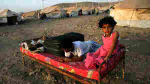 Syrian-Kurdish children sit on a bed at the Quru Gusik refugee camp in the Kurdish region of northern Iraq, on Aug. 22. Faced with brutal violence and soaring prices, thousands of Syrian Kurds have poured into Iraq's autonomous Kurdish region. UNICEF has reported that over one million Syrian children live as refugees in other countries.