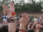 Hands raised up high, clapping at a concert. Hands raised up high, clapping at a concert.