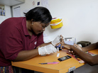 A nurse takes a blood sample from Nkosi Minenhle, 15, in a mobile clinic set up to test students for HIV at Madwaleni High School in KwaZulu Natal, South Africa. A nurse takes a blood sample from Nkosi Minenhle, 15, in a mobile clinic set up to test students for HIV at Madwaleni High School in KwaZulu Natal, South Africa.