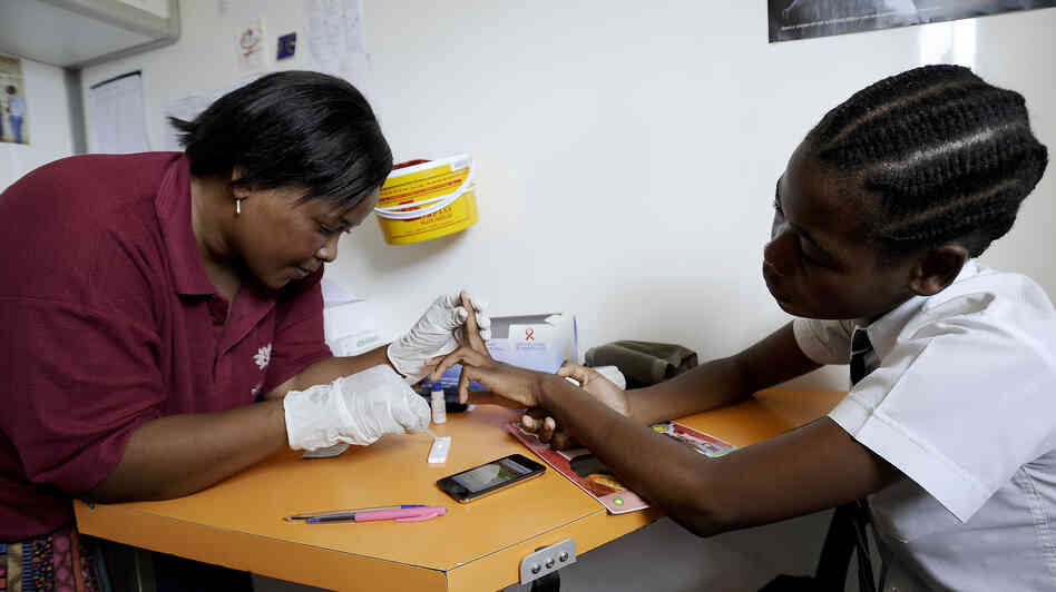 A nurse takes a blood sample from Nkosi Minenhle, 15, in a mobile clinic set up to test students for HIV at Madwaleni High School in KwaZulu Natal, South Africa. A nurse takes a blood sample from Nkosi Minenhle, 15, in a mobile clinic set up to test students for HIV at Madwaleni High School in KwaZulu Natal, South Africa.
