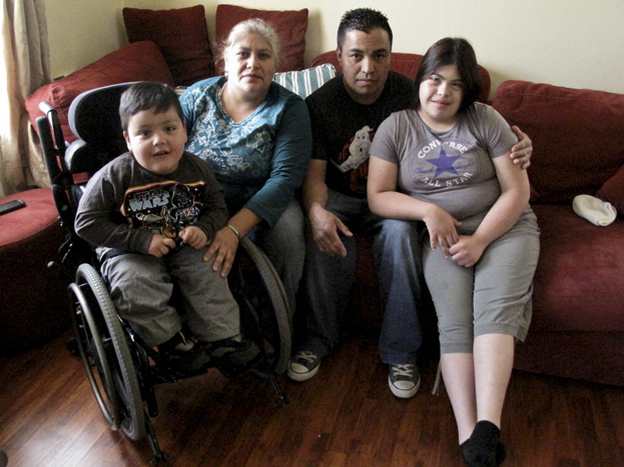 The local playground's design doesn't work for 3-year-old Emmanuel Soto, shown here with his family. Emmanuel has spina bifida. (Image credit: Julie Caine for NPR)