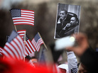 A spectator on the National Mall holds an image of President Obama and Martin Luther King during the 2013 presidential inauguration in January. A spectator on the National Mall holds an image of President Obama and Martin Luther King during the 2013 presidential inauguration in January.