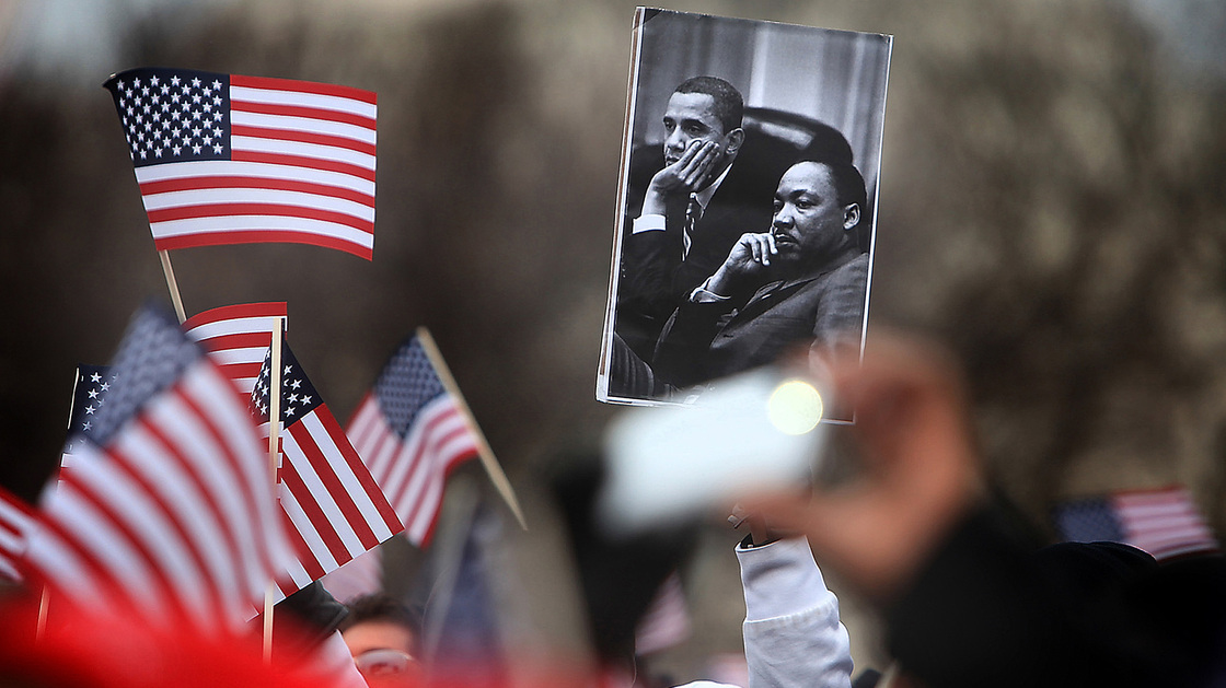 A spectator on the National Mall holds an image of President Obama and Martin Luther King during the 2013 presidential inauguration in January.