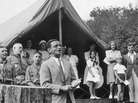 American composer Irving Berlin sings his song "God Bless America" in front of Boy Scouts troop members and spectators gathered at a tent in Monticello, New York in 1940. Instead of collecting royalties from "God Bless America," Berlin created a fund that collected and distributed them to the Boy and Girl Scouts. American composer Irving Berlin sings his song "God Bless America" in front of Boy Scouts troop members and spectators gathered at a tent in Monticello, New York in 1940. Instead of collecting royalties from "God Bless America," Berlin created a fund that collected and distributed them to the Boy and Girl Scouts.