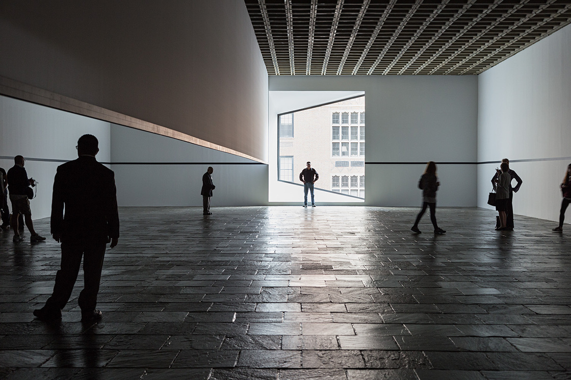 Visitors explore Robert Irwin's Scrim Veil--Black Rectangle--Natural Light during its 2013 reprise at the Whitney Museum of American Art.