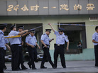 Police officers walk out from the main gate of Weng's Cold Storage Industrial Co. Ltd. at the outskirts of Shanghai, China, on Saturday. Police officers walk out from the main gate of Weng's Cold Storage Industrial Co. Ltd. at the outskirts of Shanghai, China, on Saturday.
