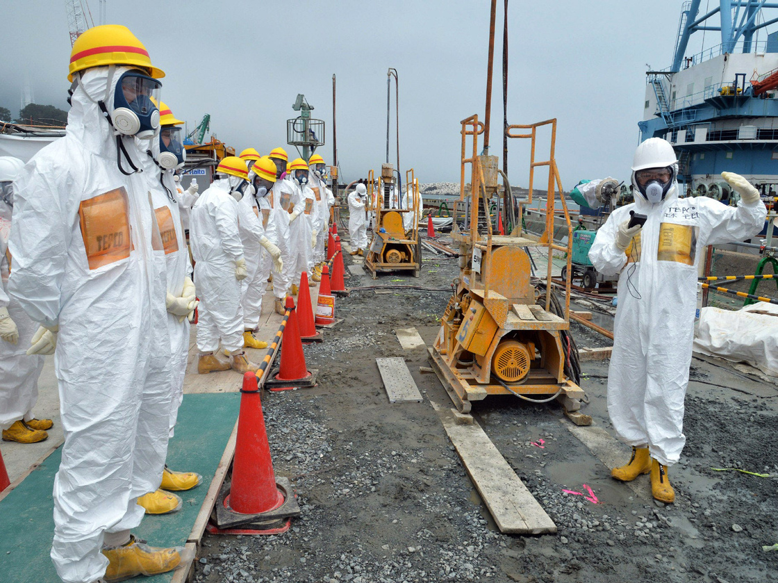 This photo taken on August 6, 2013 shows local government officials and nuclear experts at Fukushima after the contaminated water was discovered.