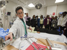 Dr. Amy Goldberg explains the medical treatment Adams received after he was shot. Part of her demonstration involves placing stickers on a student volunteer to mark bullet entry and exit points. Dr. Amy Goldberg explains the medical treatment Adams received after he was shot. Part of her demonstration involves placing stickers on a student volunteer to mark bullet entry and exit points.