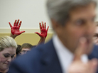 As Secretary of State John Kerry spoke to the House Foreign Affairs Committee on Wednesday, "Code Pink" protesters behind him held up "bloody hands" to express their opposition to the prospect of U.S. military strikes on Syria. As Secretary of State John Kerry spoke to the House Foreign Affairs Committee on Wednesday, "Code Pink" protesters behind him held up "bloody hands" to express their opposition to the prospect of U.S. military strikes on Syria.