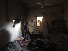 A rebel fighter takes cover inside a damaged building in the eastern Syrian city of Deir al-Zor on Tuesday. The U.S. is training a small number of rebels and has pledged to provide them with arms. A rebel fighter takes cover inside a damaged building in the eastern Syrian city of Deir al-Zor on Tuesday. The U.S. is training a small number of rebels and has pledged to provide them with arms.