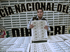A policeman shows printed sheets of counterfeit bills seized by Peruvian police. A policeman shows printed sheets of counterfeit bills seized by Peruvian police.