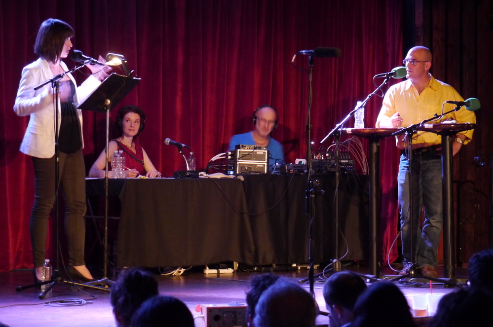 Wait, Wait...Don't Tell Me! host Peter Sagal stands poised and ready for the next perplexing question from Ask Me Another host Ophira Eisenberg, on stage at The Bell House in Brooklyn, NY. Wait, Wait...Don't Tell Me! host Peter Sagal stands poised and ready for the next perplexing question from Ask Me Another host Ophira Eisenberg, on stage at The Bell House in Brooklyn, NY.