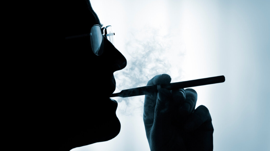 A man smokes an electronic cigarette.