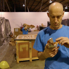 A man calmly opens a bag of pretzels while another is mauled by a tiger in this scene from The Polyphonic Spree's "Raise Your Head" video. A man calmly opens a bag of pretzels while another is mauled by a tiger in this scene from The Polyphonic Spree's "Raise Your Head" video.