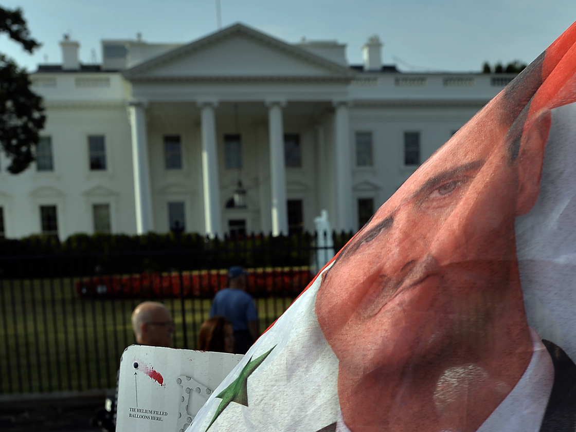 In Washington, D.C., this week, there have been demonstrations both in favor of and against a military strike on targets in Syria. Outside the White House on Monday, supporters of Syrian President Bashar Assad waved a Syrian flag with his face on it.