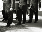 Pallbearers carry a coffin at a funeral. Pallbearers carry a coffin at a funeral.