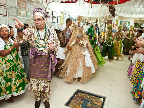 Candomblé prêtre Pai Nelson guides gens qui sont possédés par Orixas ou esprits de divinités, de retour à un temple Sao Paulo, après ils ont changé en costumes Orixá. Candomblé prêtre Pai Nelson guides gens qui sont possédés par Orixas ou esprits de divinités, de retour à un temple Sao Paulo, après ils ont changé en costumes Orixá.