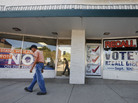 A man walks past a Democratic campaign office (left) and a pro-gun-group's office, which display signs against, and in favor of, recalling Democratic state Sen. Angela Giron, on the day of the Sept. 10 recall vote in Pueblo, Colo. A man walks past a Democratic campaign office (left) and a pro-gun-group's office, which display signs against, and in favor of, recalling Democratic state Sen. Angela Giron, on the day of the Sept. 10 recall vote in Pueblo, Colo.
