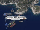 An aerial view taken on Aug. 23 shows the Costa Concordia as it lies on its side next to Giglio Island. The wrecked cruise ship will be rolled off the seabed and onto underwater platforms. An aerial view taken on Aug. 23 shows the Costa Concordia as it lies on its side next to Giglio Island. The wrecked cruise ship will be rolled off the seabed and onto underwater platforms.