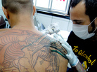 As NPR's Scott Simon observes, a lot of tattoo parlors' business comes from walk-in clients "who want to leave with a dragon on their shoulder." That's the case whether the tattoo shop is in Washington, D.C., or — as in this image — in Sao Paulo. As NPR's Scott Simon observes, a lot of tattoo parlors' business comes from walk-in clients "who want to leave with a dragon on their shoulder." That's the case whether the tattoo shop is in Washington, D.C., or — as in this image — in Sao Paulo.