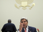 A Code Pink protester holds up a red-painted hand behind Secretary of State John Kerry as he testifies on Capitol Hill on Sept. 4 about possible military strikes on Syria. A Code Pink protester holds up a red-painted hand behind Secretary of State John Kerry as he testifies on Capitol Hill on Sept. 4 about possible military strikes on Syria.