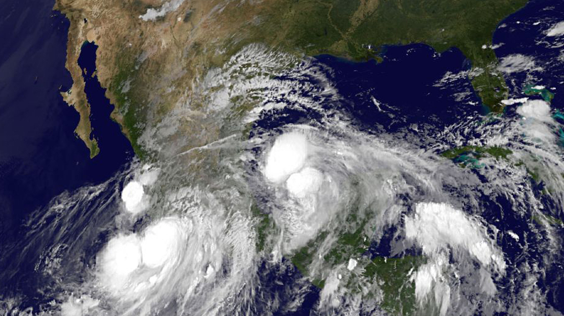 An image provided by NOAA taken at 2:45 a.m. EDT Sunday shows Hurricane Ingrid approaching from the Gulf of Mexico and Tropical Storm Manuel just off the western coast of Mexico.