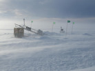 The surface tower at a drill site, under construction during blistering Antarctic winds. Data from instruments, deployed through 450 meters of ice, is transmitted from the tower by satellite back to the Naval Postgraduate School. The surface tower at a drill site, under construction during blistering Antarctic winds. Data from instruments, deployed through 450 meters of ice, is transmitted from the tower by satellite back to the Naval Postgraduate School.
