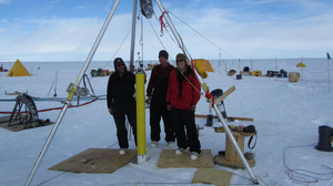 The Naval Postgraduate School team deploys ocean monitoring instruments through a bore hole into the ocean cavity below.