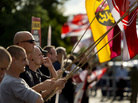 NPD Party activists hold up German flags in the Hellersdorf-Marzahn district of Berlin last month, as they protest a new home for asylum seekers. NPD Party activists hold up German flags in the Hellersdorf-Marzahn district of Berlin last month, as they protest a new home for asylum seekers.