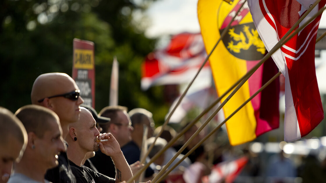 NPD Party activists hold up German flags in the Hellersdorf-Marzahn district of Berlin