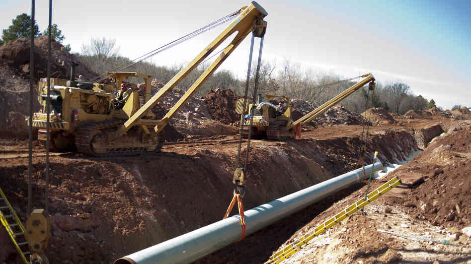 A 60-foot section of pipe is lowered into a trench during construction of the Gulf Coast Pipeline in Prague, Okla., in March. The Gulf Coast Pipeline, a 485-mile crude oil line, is part of the Keystone XL project and will run from Cushing, Okla. to Nederland, Texas. Although this southern stretch of the pipeline is nearly finished, the northern stretch is still under study. A 60-foot section of pipe is lowered into a trench during construction of the Gulf Coast Pipeline in Prague, Okla., in March. The Gulf Coast Pipeline, a 485-mile crude oil line, is part of the Keystone XL project and will run from Cushing, Okla. to Nederland, Texas. Although this southern stretch of the pipeline is nearly finished, the northern stretch is still under study.