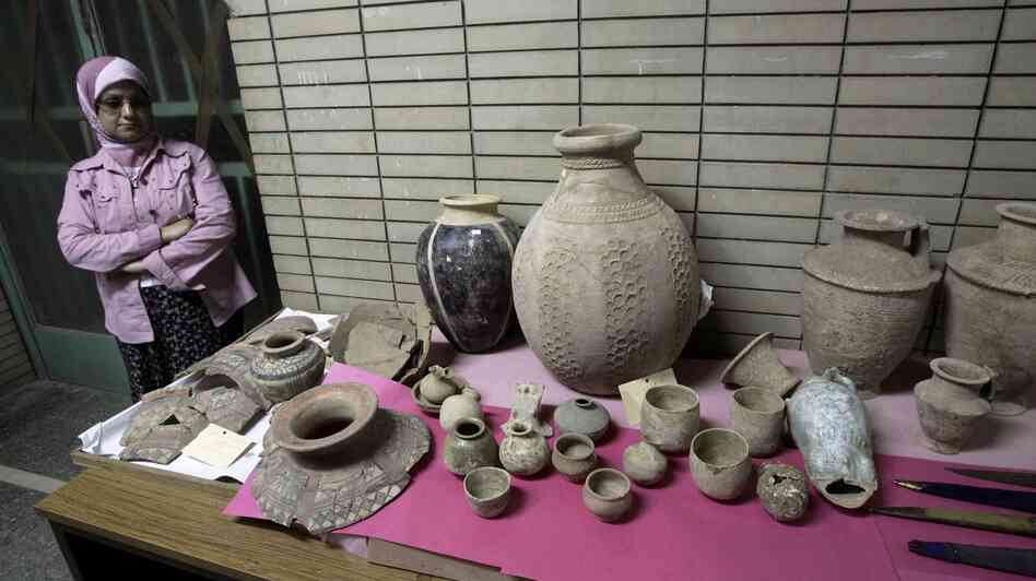 A woman stands next to a display of recovered antiquities at the Iraqi National Museum in Baghdad, Iraq on April 27, 2008. The Iraqi National Museum has welcomed home 701 artifacts that were stolen during looting after Saddam Hussein's ouster in 2003. A woman stands next to a display of recovered antiquities at the Iraqi National Museum in Baghdad, Iraq on April 27, 2008. The Iraqi National Museum has welcomed home 701 artifacts that were stolen during looting after Saddam Hussein's ouster in 2003.