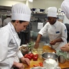 Fourth year Tulane medical school student Neha Solanki (far right) preps a Greek frittata during a class at Johnson & Wales.
