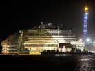 The Costa Concordia is seen after it was lifted upright on the Tuscan Island of Giglio, Italy, early Tuesday morning. Officials declared the results of the 19-hour operation "perfect." The Costa Concordia is seen after it was lifted upright on the Tuscan Island of Giglio, Italy, early Tuesday morning. Officials declared the results of the 19-hour operation "perfect."
