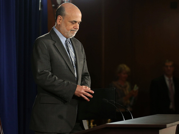 Federal Reserve Chairman Ben Bernanke arrives to speak at a news conference Wednesday in Washington, D.C. The Fed cut its economic growth forecasts and said it would keep buying bonds in a bid to keep interest rates down. (Image credit: Getty Images)