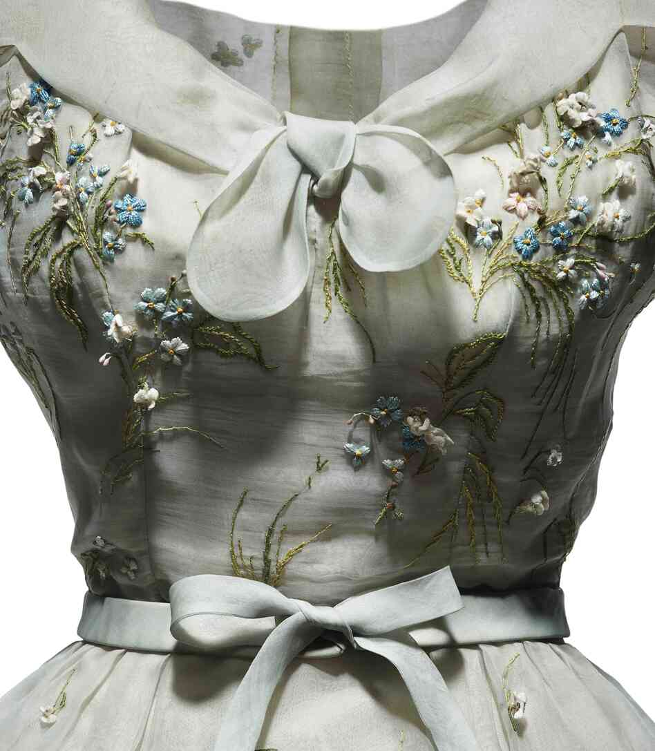 An afternoon dress in pale blue organdie, embroidered with pink and blue forget-me-nots, was part of Dior's spring-summer 1953 haute couture collection, Tulipe line. An afternoon dress in pale blue organdie, embroidered with pink and blue forget-me-nots, was part of Dior's spring-summer 1953 haute couture collection, Tulipe line.