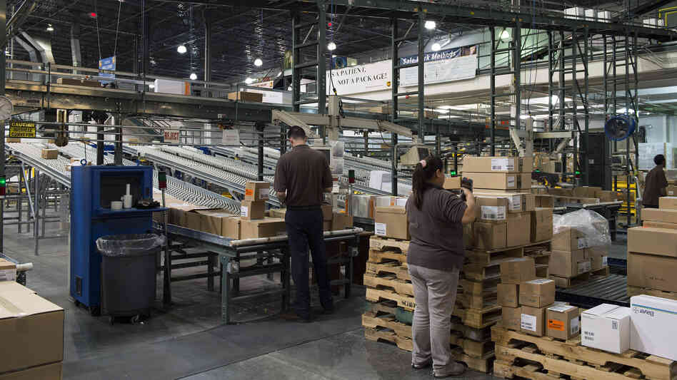 Workers prepare orders to be loaded for shipment at a UPS Healthcare Supply Chain and Distribution Center in Atlanta on March 12. The company recently announced that it would no longer offer coverage for spouses who had their own job-based insurance. Workers prepare orders to be loaded for shipment at a UPS Healthcare Supply Chain and Distribution Center in Atlanta on March 12. The company recently announced that it would no longer offer coverage for spouses who had their own job-based insurance.