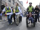 A Boston police officer wheels an injured boy down Boylston Street as medical workers carry an injured runner after the Boston Marathon bombing in April. A Boston police officer wheels an injured boy down Boylston Street as medical workers carry an injured runner after the Boston Marathon bombing in April.