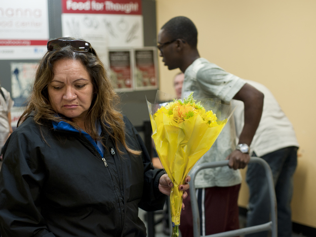 Judith Prado picks a bouquet of flowers to take with her other donations from the food pantry. (Image credit: NPR)