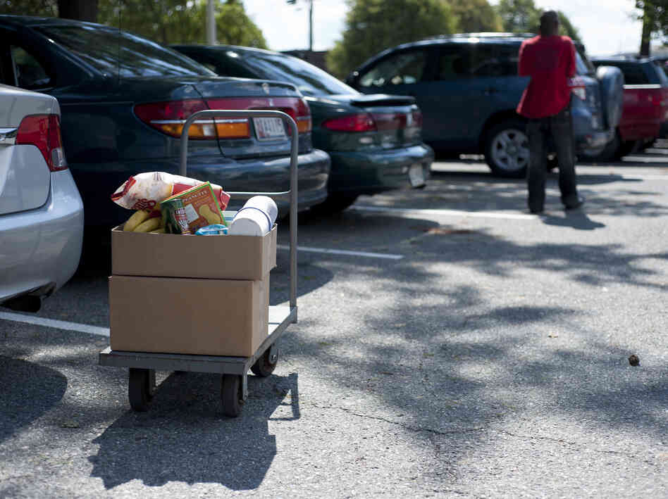 Food distributed by the Manna Food Center is packed in cardboard boxes to be loaded into clients' cars. Food distributed by the Manna Food Center is packed in cardboard boxes to be loaded into clients' cars.