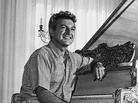 Liberace sits at a gold-leafed piano in the living room of his then-new Hollywood mansion in November 1961. Liberace sits at a gold-leafed piano in the living room of his then-new Hollywood mansion in November 1961.